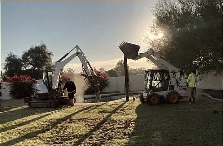 Machines still working as the light goes.