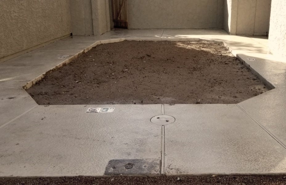 Flat compacted ground where the pool was, the surrounding deck left intact.